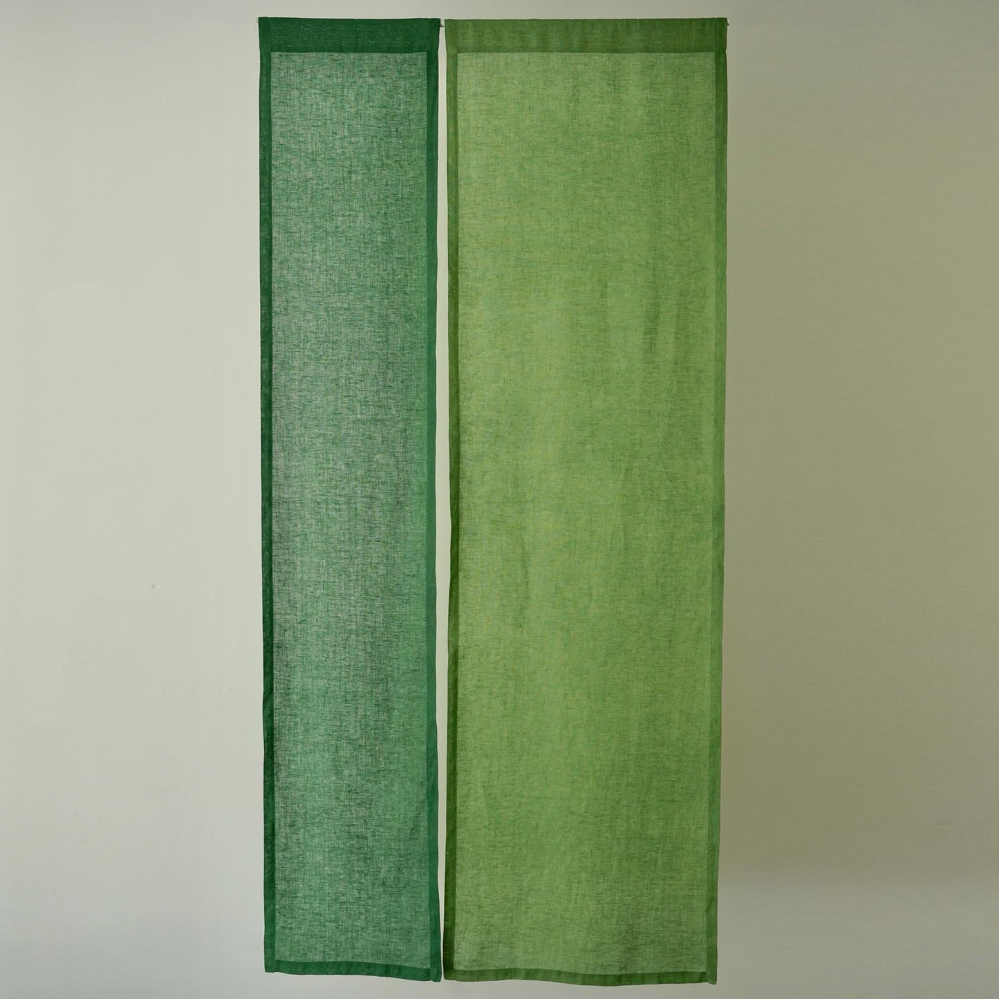 alternate angle of Soft Tone Noren — Leaf Green hanging as a two-panel doorway curtain