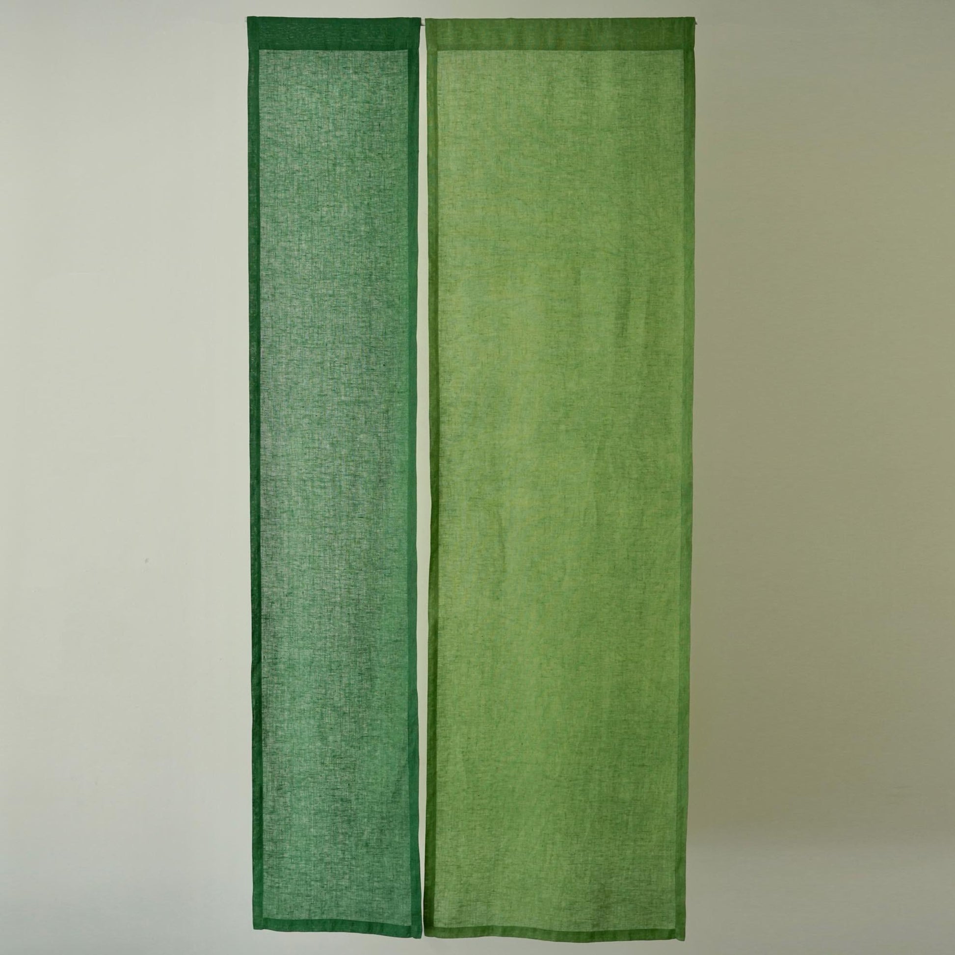 alternate angle of Soft Tone Noren — Leaf Green hanging as a two-panel doorway curtain