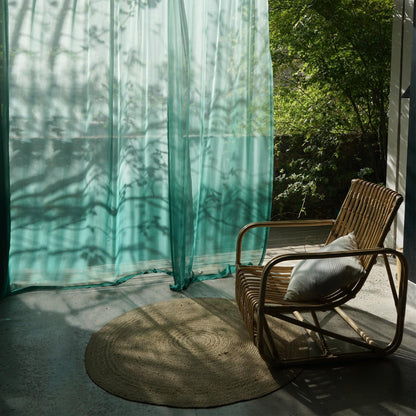 Sheer Curtain — Emerald Blue shown in a bedroom or living room setting