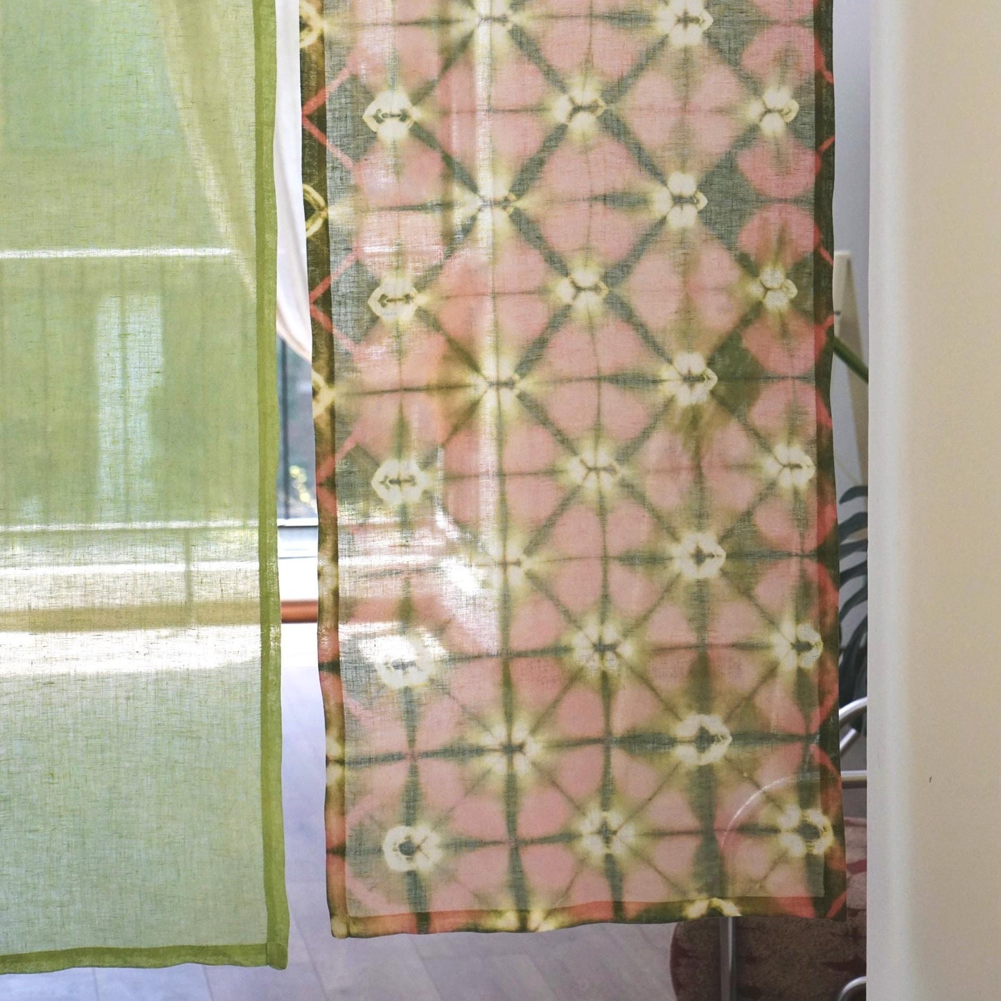 close-up of Motif Linen Noren — Peach showing the natural resist-dye motif on linen