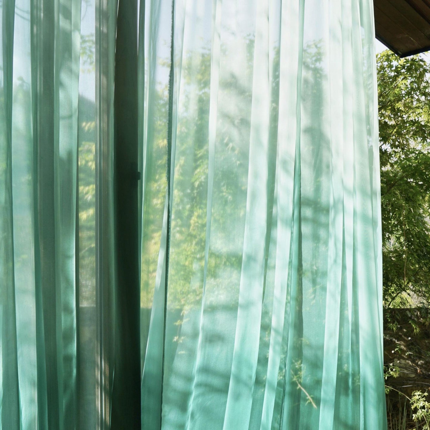 alternate interior view with Sheer Curtain — Emerald Blue filtering soft daylight