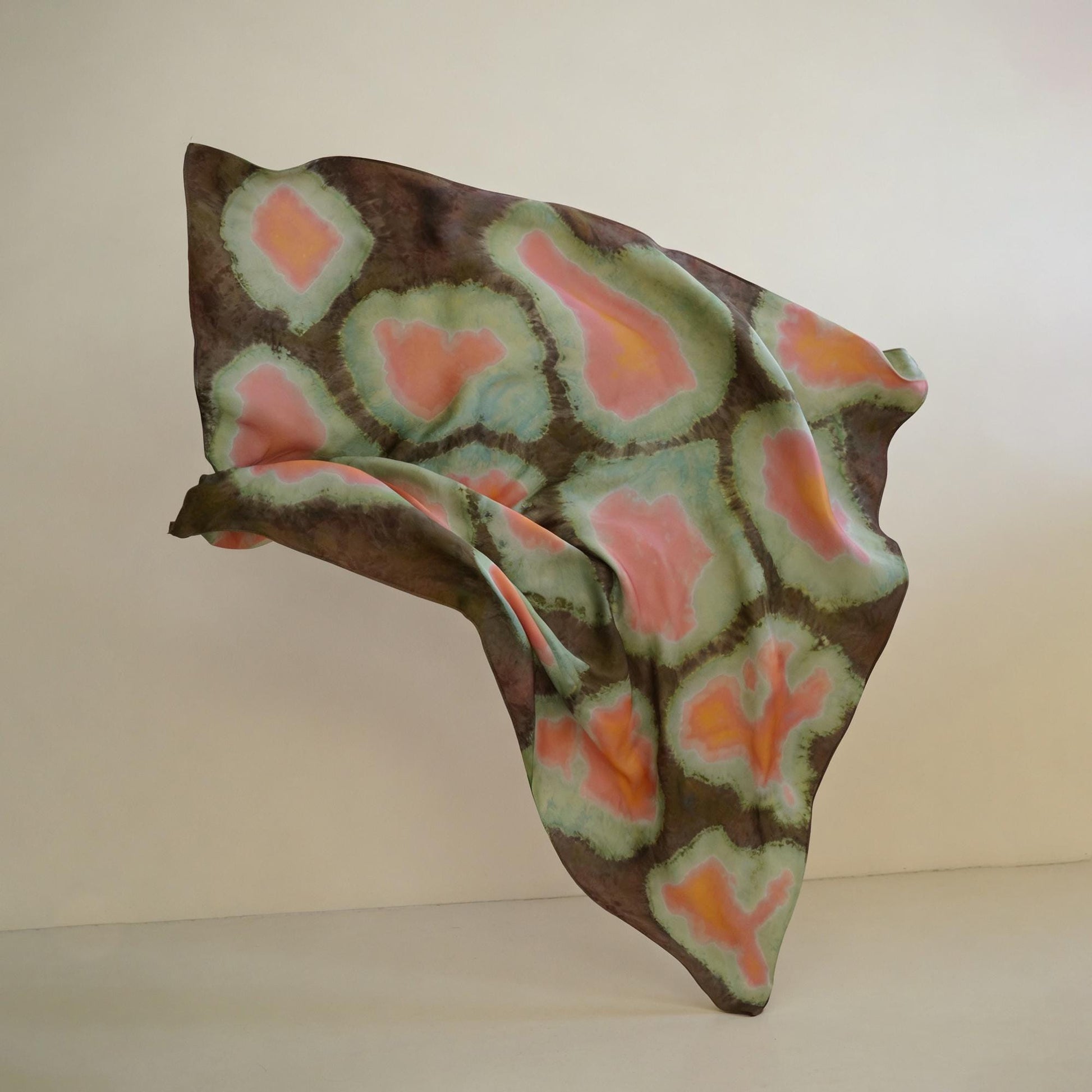 flat-lay view of Scarf — Clay Green highlighting the natural dye and motif